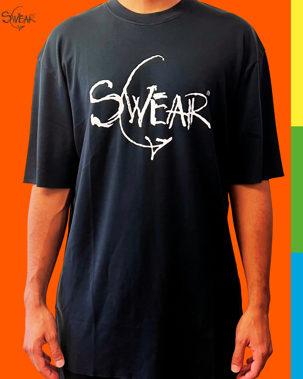A person wearing a black oversized T-shirt with a large white 'SWEAR' graphic across the chest, shown against a bright orange background with a vertical multicolor stripe on the right edge.